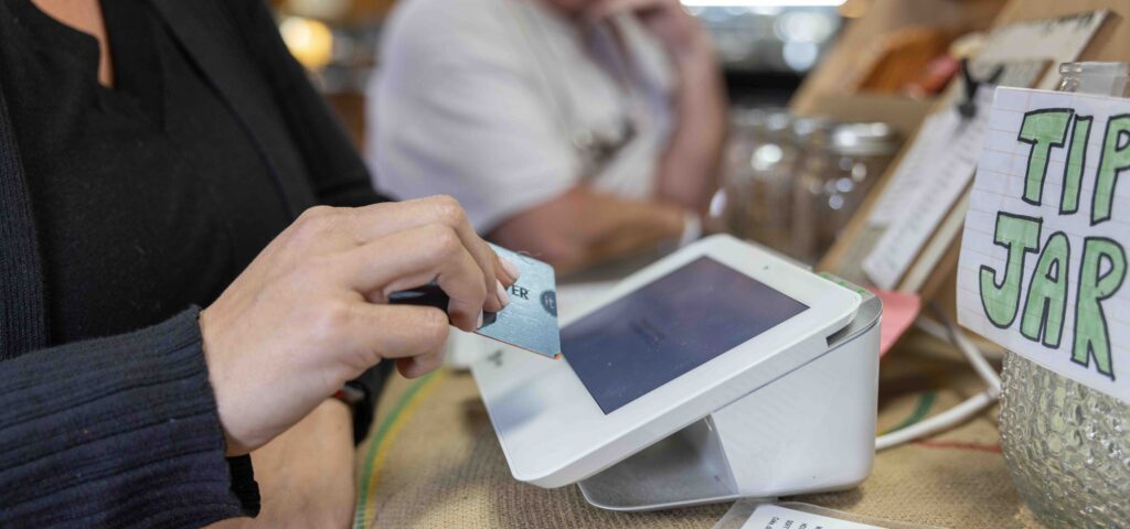 Person paying with a card at a small business